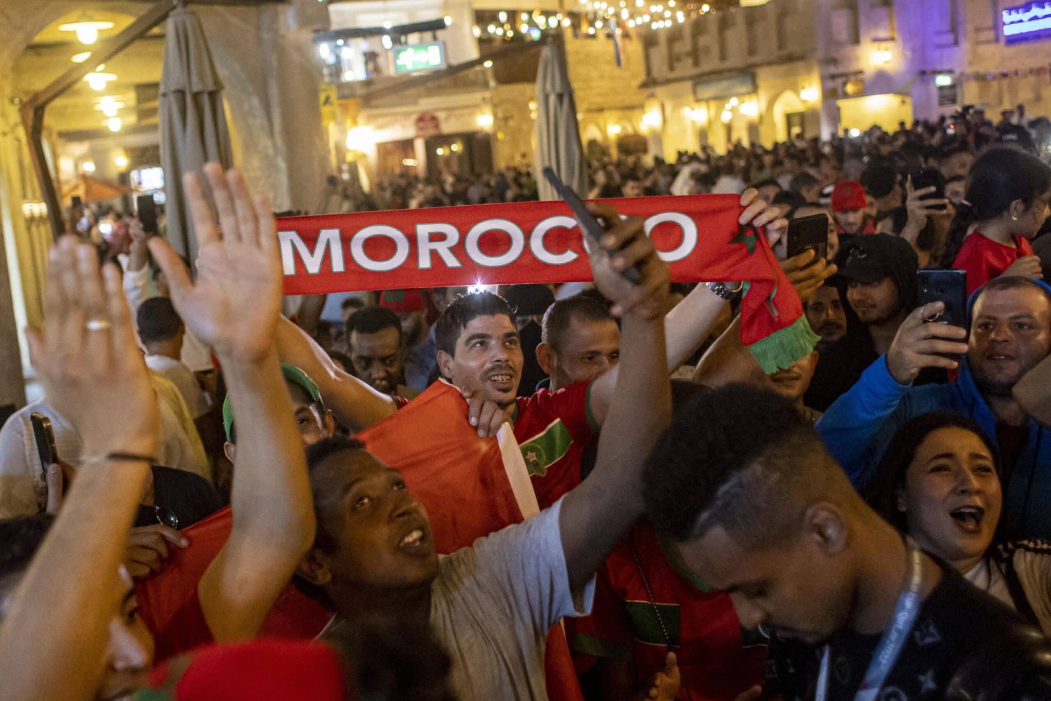 epa10342437 Fans of Marocco celebrate in the Souq Waqif market in Doha, Qatar, 01 December 2022, after their team won the FIFA World Cup 2022 group F match against Canada and advanced to the next roundm of the tournament. EPA/MARTIN DIVISEK